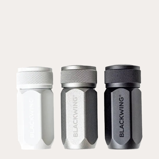 Three Blackwing pencil sharpeners on a light grey background