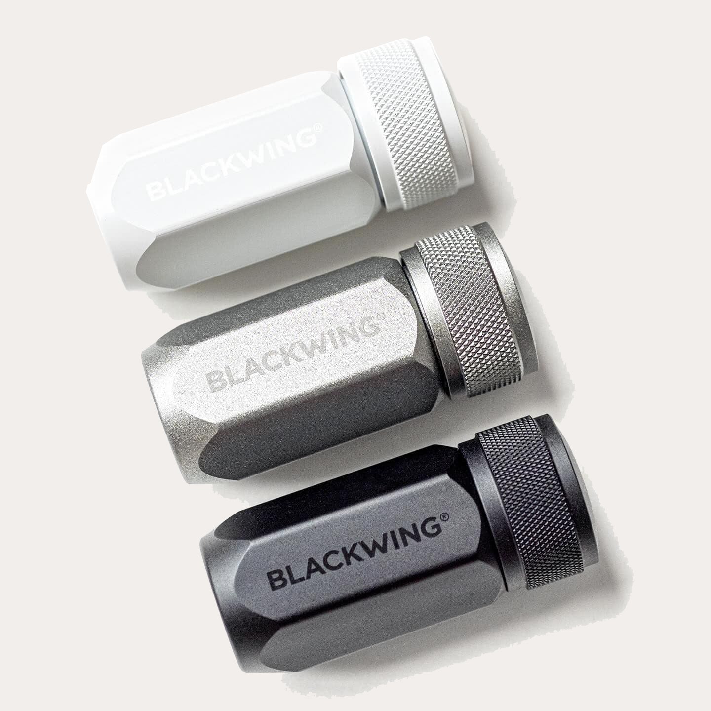 Three Blackwing pencil sharpeners on a light grey background