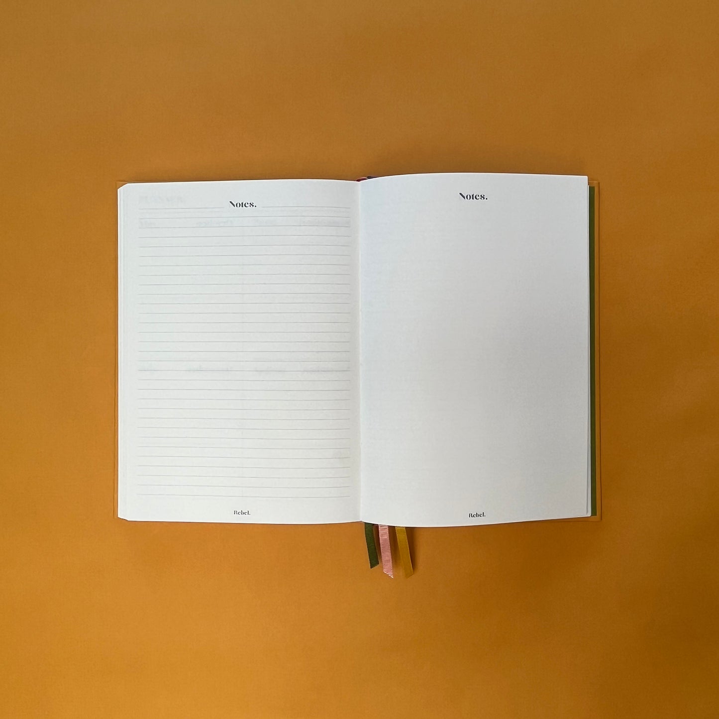 Notes spread of Rebel Stationery's Gold Seasonal notebook (yellow cover with pink linen spine) on a yellow background