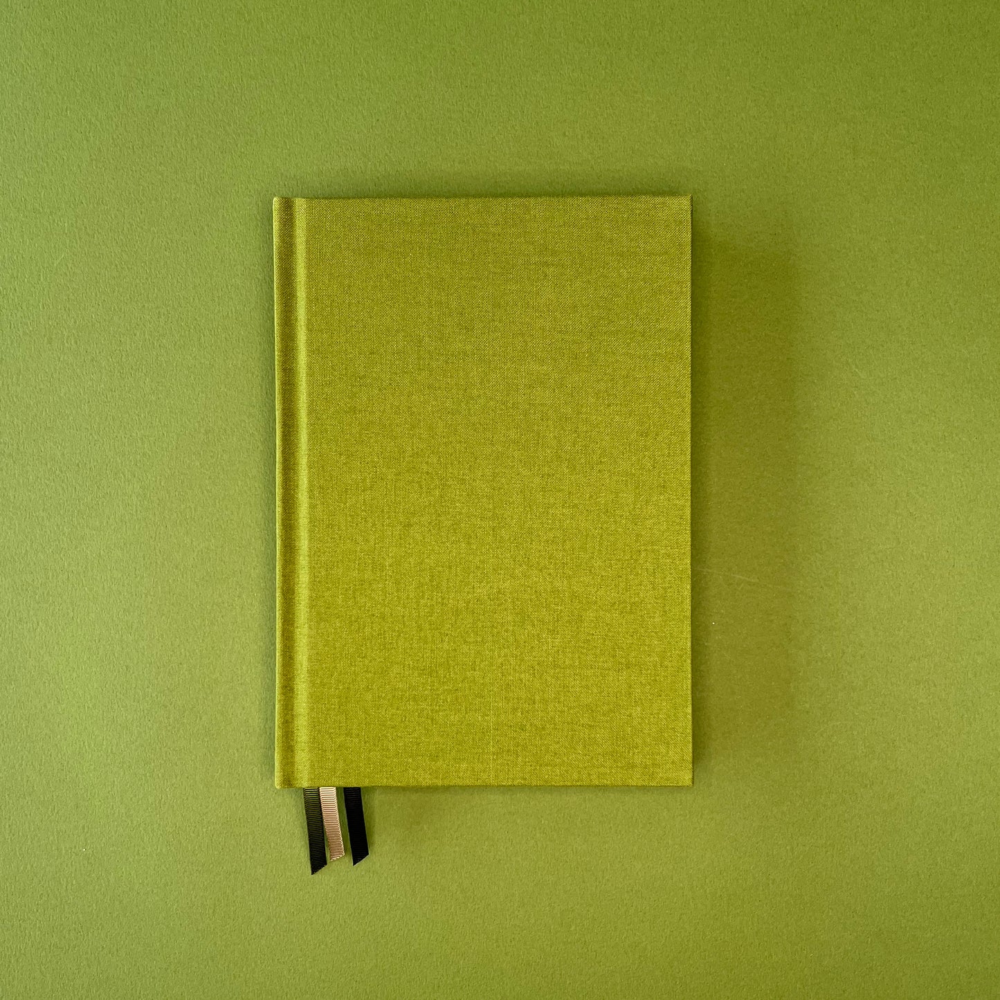 Front cover of Rebel Stationery's Signature notebook in Moss on green background