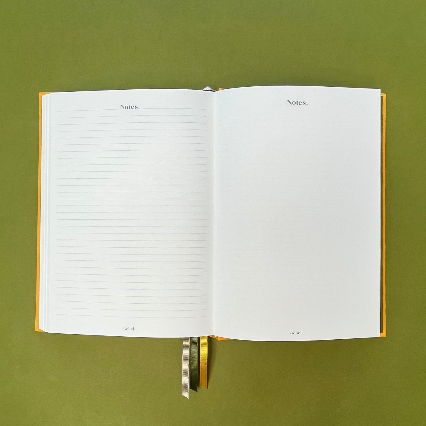 Notes spread of Rebel Stationery's Signature A5 diary in yellow bookcloth, on a green backround