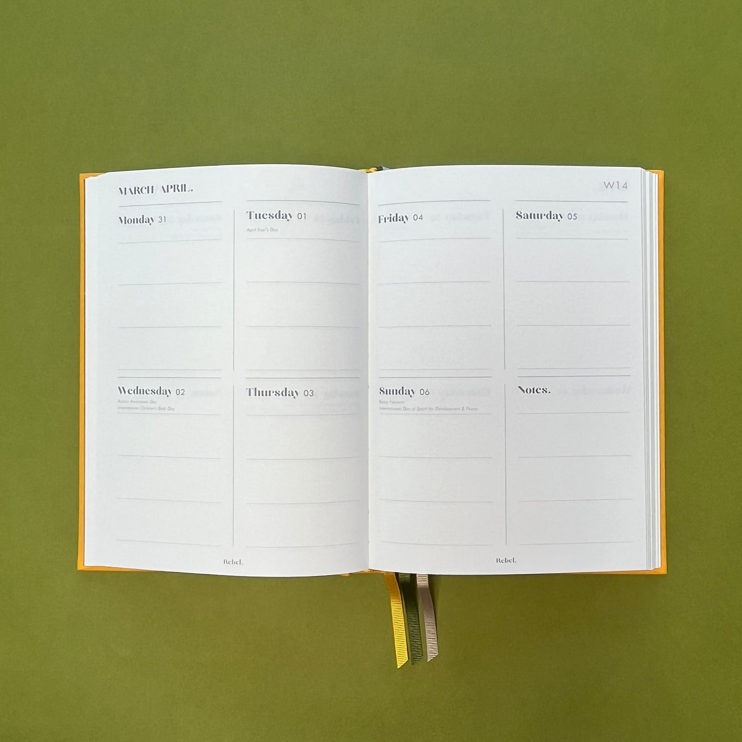 WTV spread of Rebel Stationery's Signature A5 diary in yellow bookcloth, on a green backround