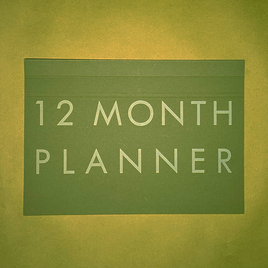 Front cover of Rebel Stationery's A4 Monthly Desk Planner in Moss on green background