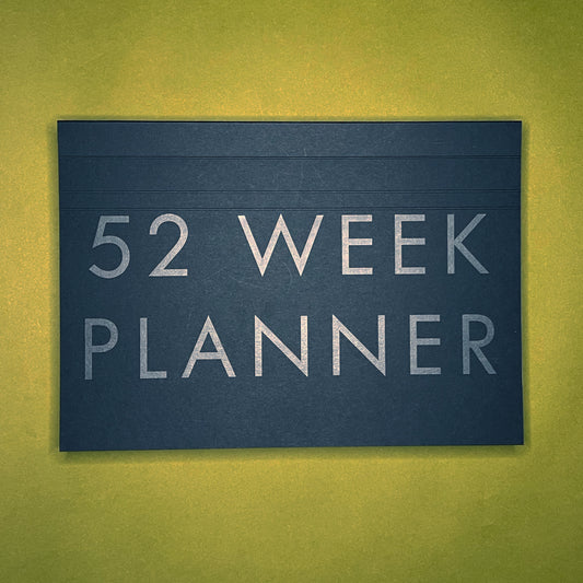 Front cover of Rebel Stationery's A4 Weekly Desk Planner in Ink on green background