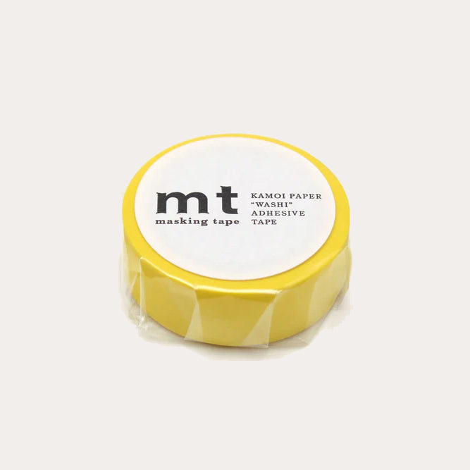 Yellow masking tape with white label on a light grey background