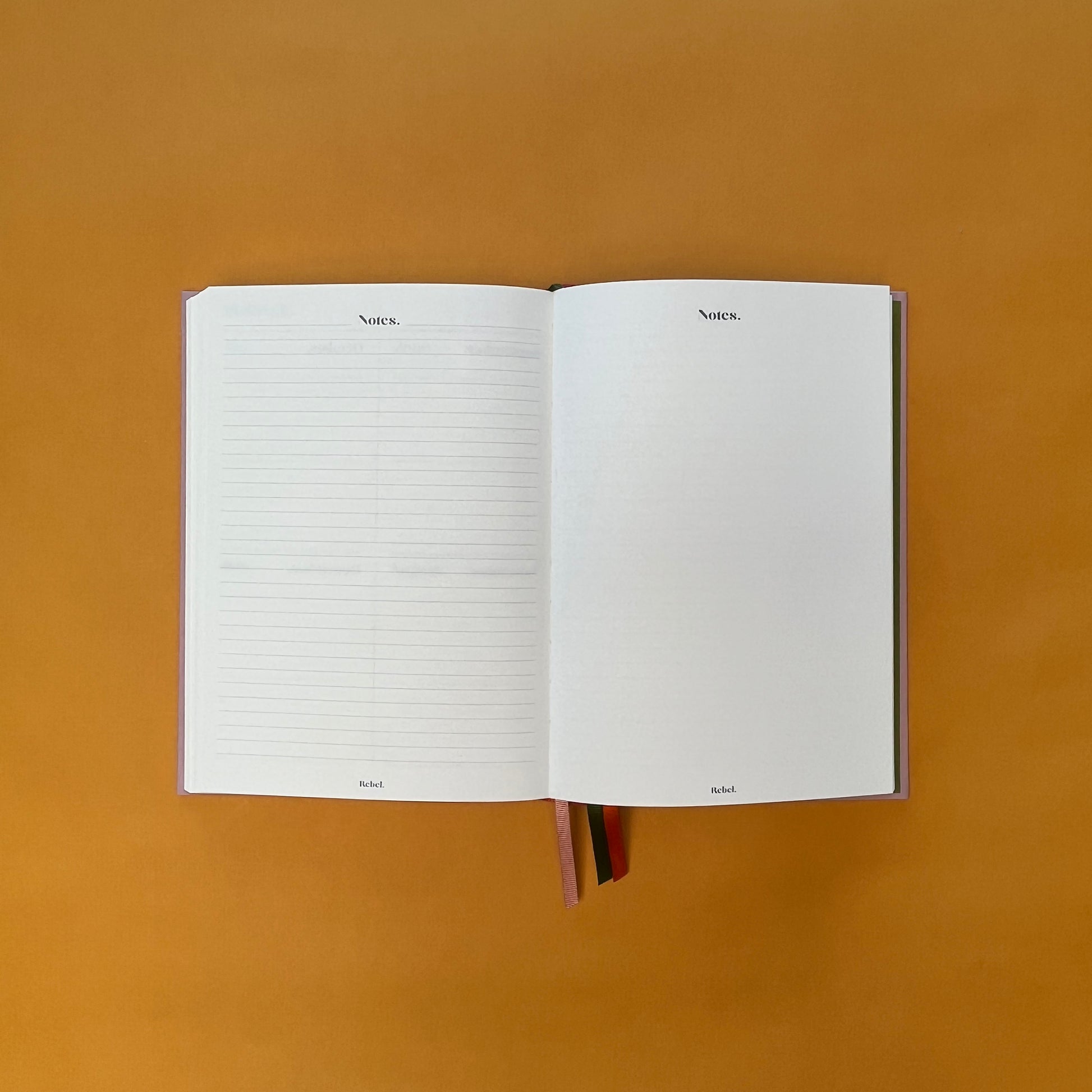 Notes spread of Rebel Stationery's Seasonal Rose notebook, a pink A5 with orange-red linen spine, on a yellow background