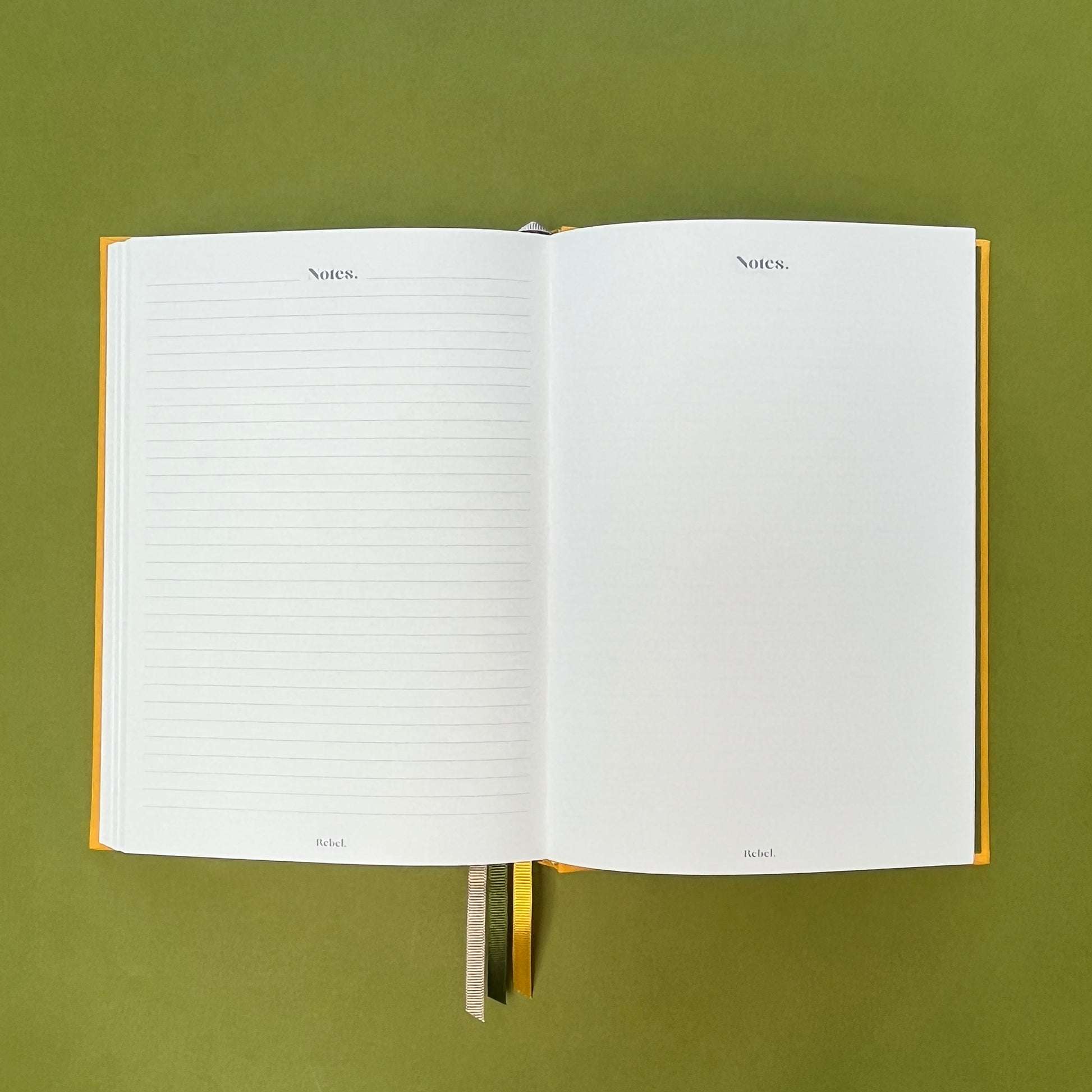 Notes spread of Rebel Stationery's Signature A5 diary in yellow bookcloth, on a green backround