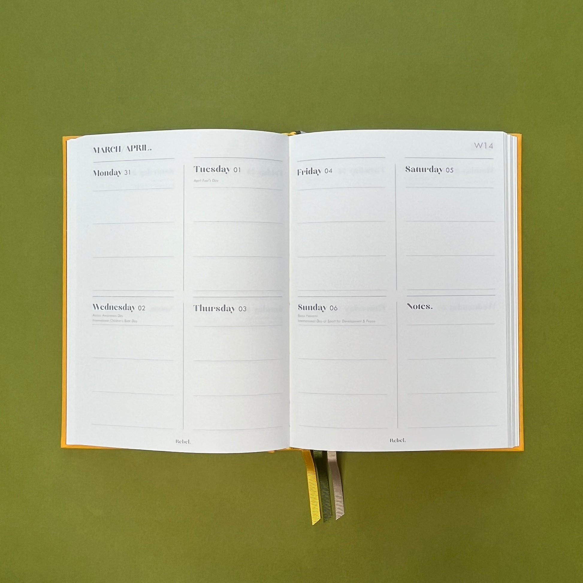 WTV spread of Rebel Stationery's Signature A5 diary in yellow bookcloth, on a green backround