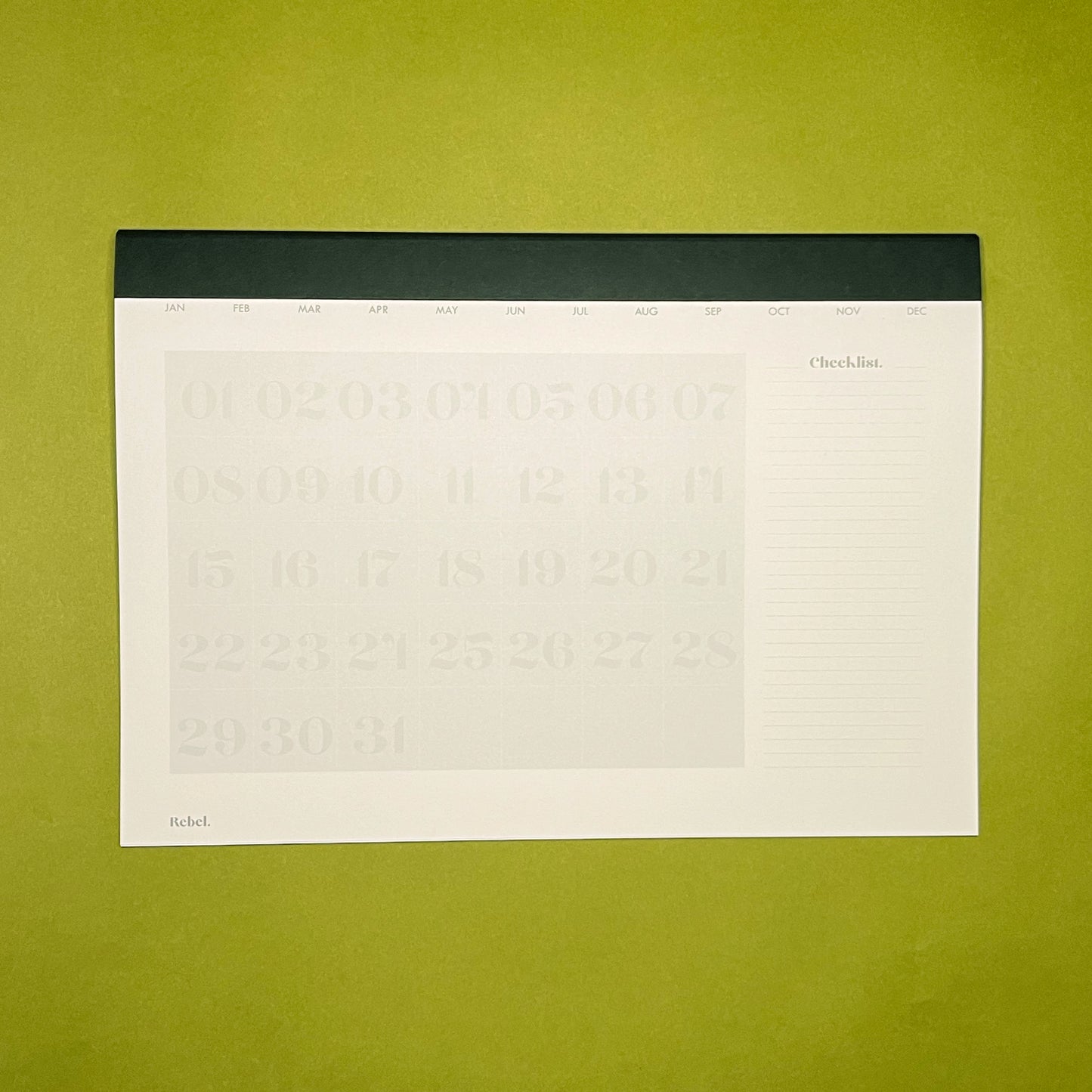 Inside spread of Rebel Stationery's A4 Monthly Desk Planner in Ink on green background