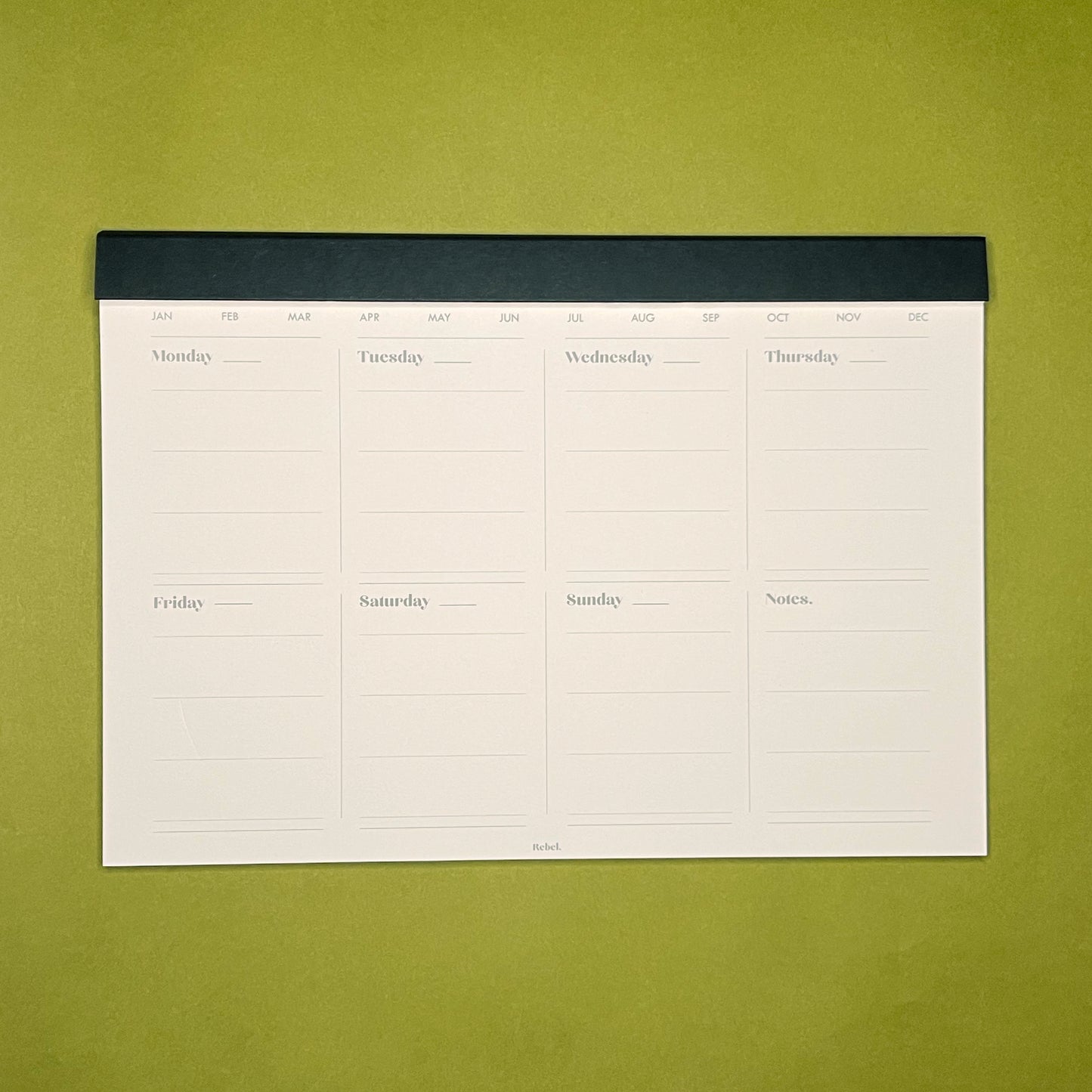 Inside spread of Rebel Stationery's A4 Weekly Desk Planner in Ink on green background
