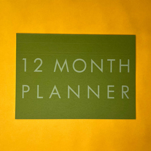 Green desk planner with printed text on yellow background