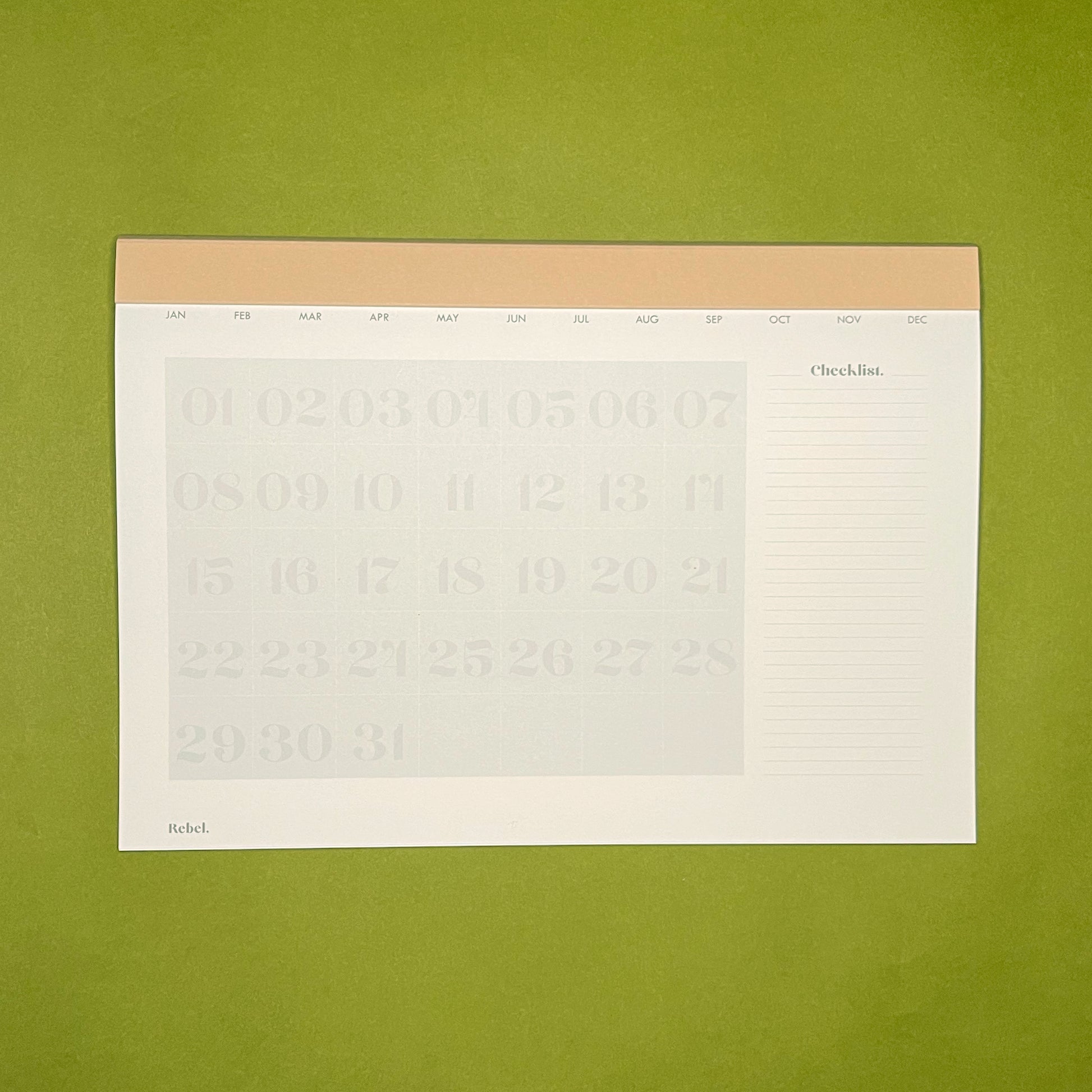 Inside spread of Rebel Stationery's Monthly Desk Planner in Stone on a green background